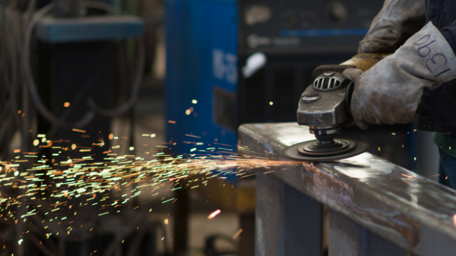 A close-up image of a CNC laser cutting machine processing a sheet of metal.
